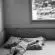 grayscale photo of person lying on bed